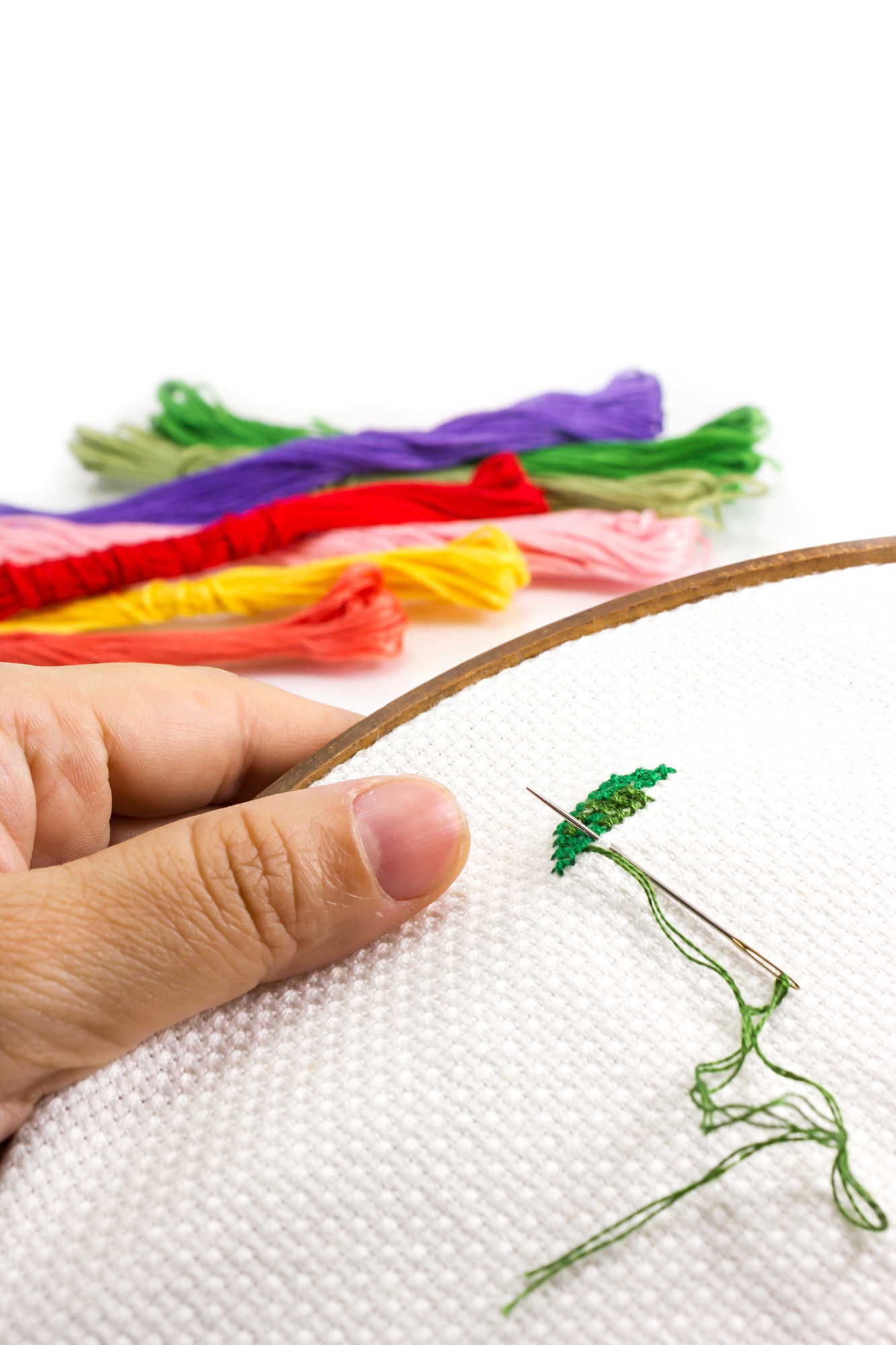hands arranging embroidered patches